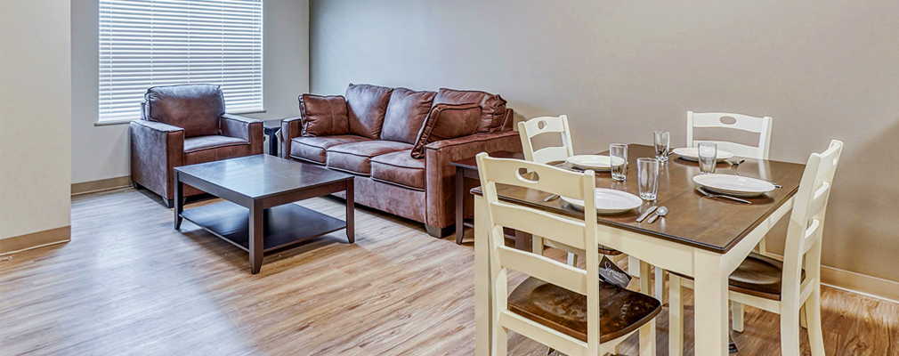 Photograph of the living and dining areas in an apartment.