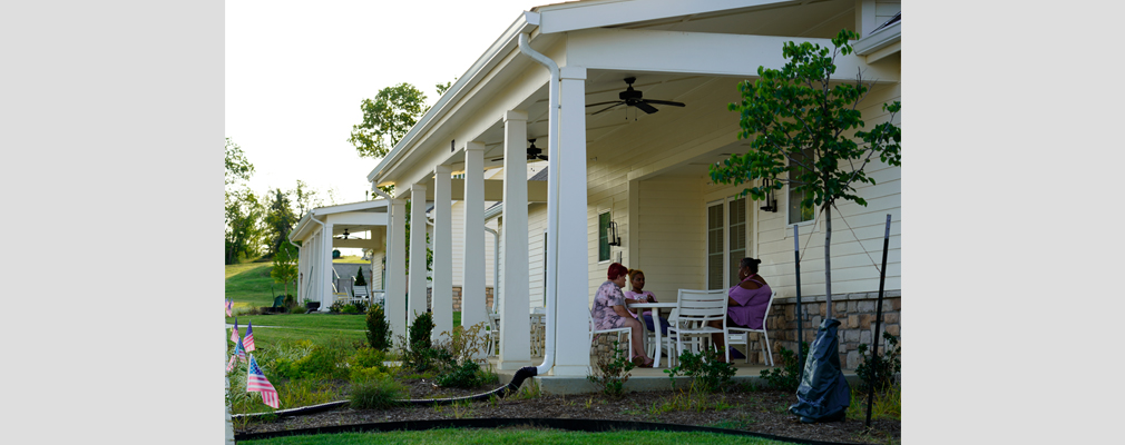 Three residents sitting around a patio table.