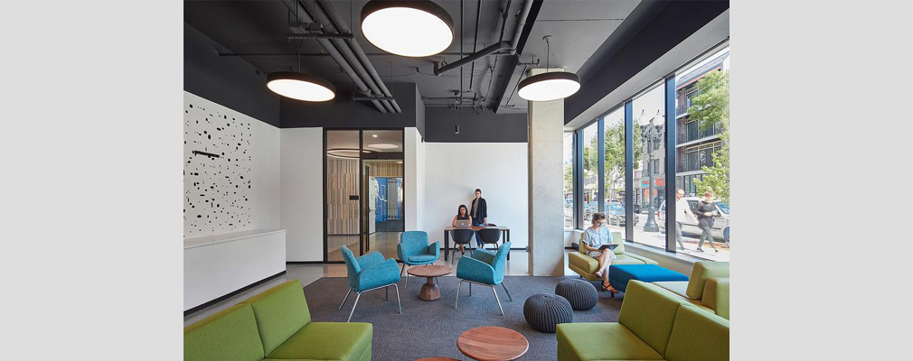 Photograph of three people in a lounge in a library.