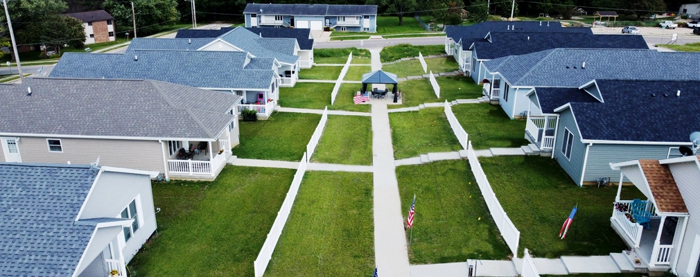 Gazebo in center of network of sidewalks connecting single-story suburban homes.
