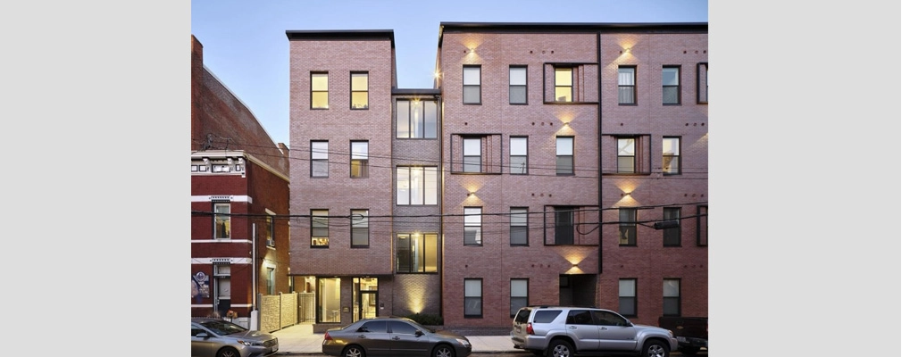 Exterior of modern, four-story apartment building.