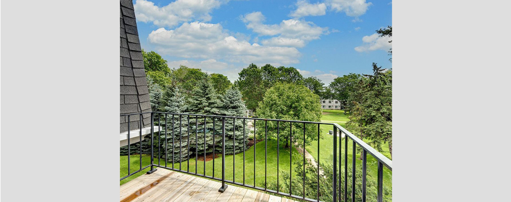 Elevated view of a park from an apartment balcony.