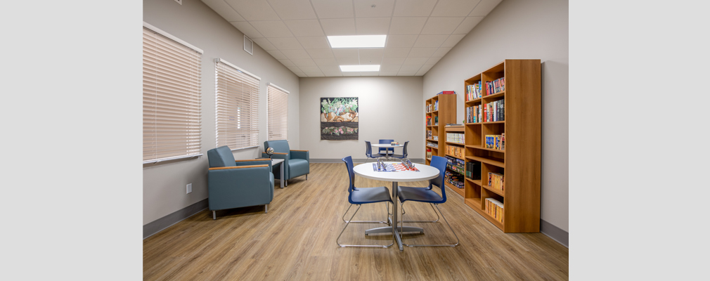 Photograph of an indoor common space at Chuck Austin Place that includes a kitchen and counters for sitting.