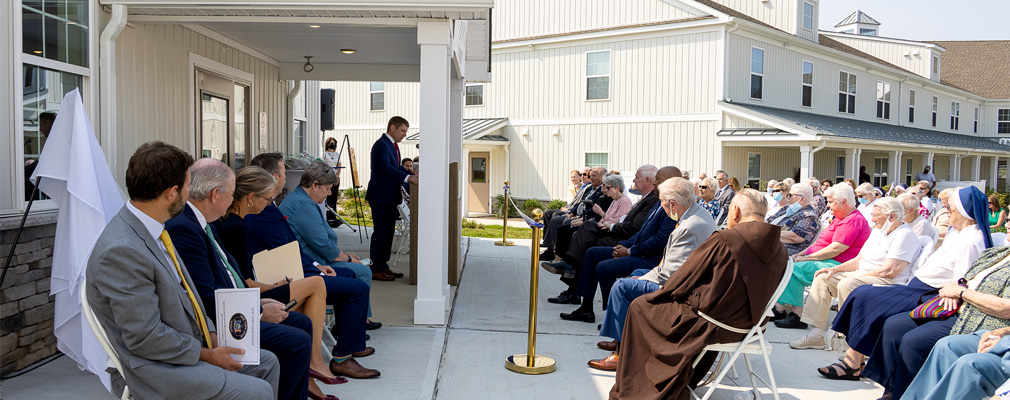 People seated at the outdoor dedication ceremony.