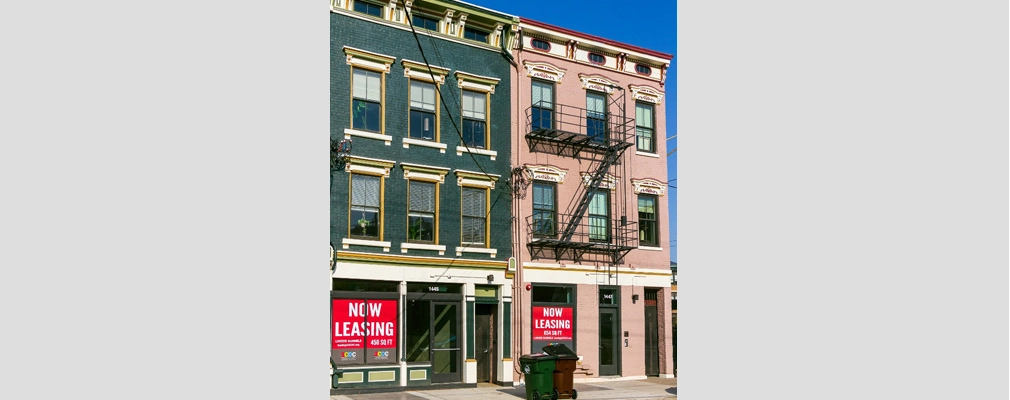 Exterior of two historic, three-story apartment buildings.