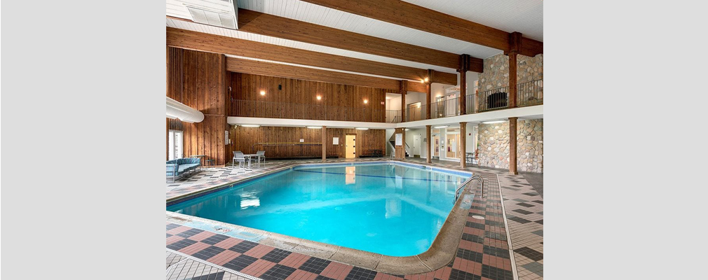 An indoor pool with two-story high walls on two sides.