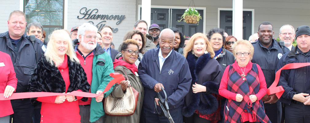 Officials gathered at the ribbon-cutting ceremony of Harmony Garden Estates.