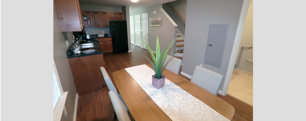 Modern kitchen with appliances and a dining area. 