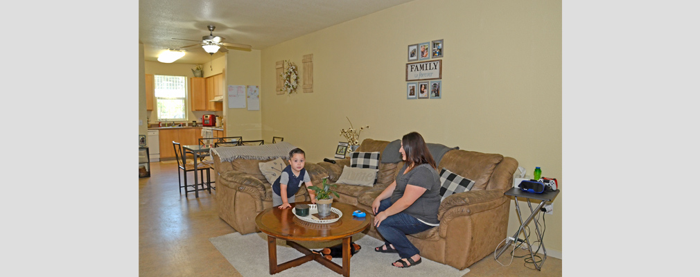 Photograph of a parent and child in a living room.