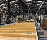 Building wall panels on an assembly line.