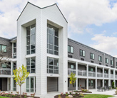 Exterior of a three-story apartment building.