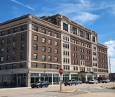 A seven-story neoclassical building with a brick façade.