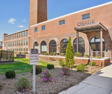 Exterior photograph of a large brick building with playground in the foreground.