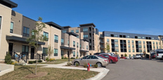 Exterior of townhouses and a five-story apartment building.