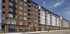 Exterior of a large seven-story apartment building.