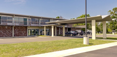 Front view of a midcentury, two-story brick building.