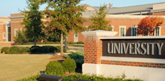 A building with a sign in front that says "University."