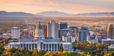 A panoramic view of Salt Lake City at sunset, showcasing a vibrant cityscape.