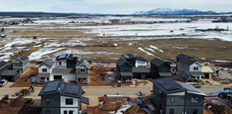 An aerial shot of the Founders Way development, which includes an L-shaped apartment building and several smaller standalone buildings.