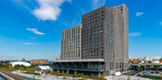 The Bronx Point building, with the Harlem River in the foreground.