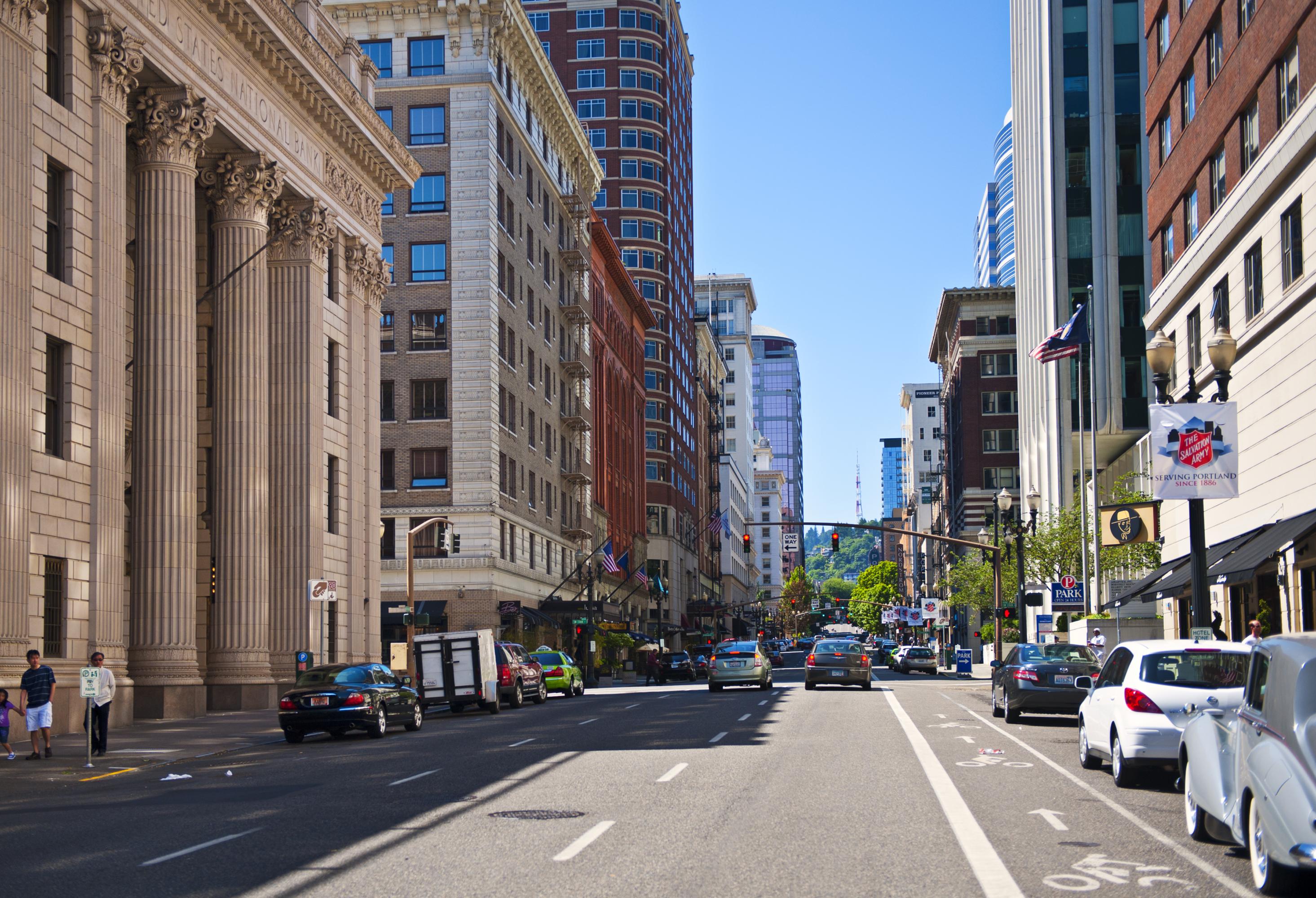 Multistory buildings along both sides of a busy street.