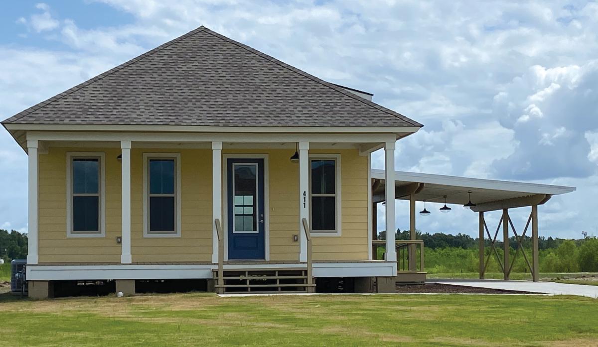 Front view of a single-story house with a car port on the side.