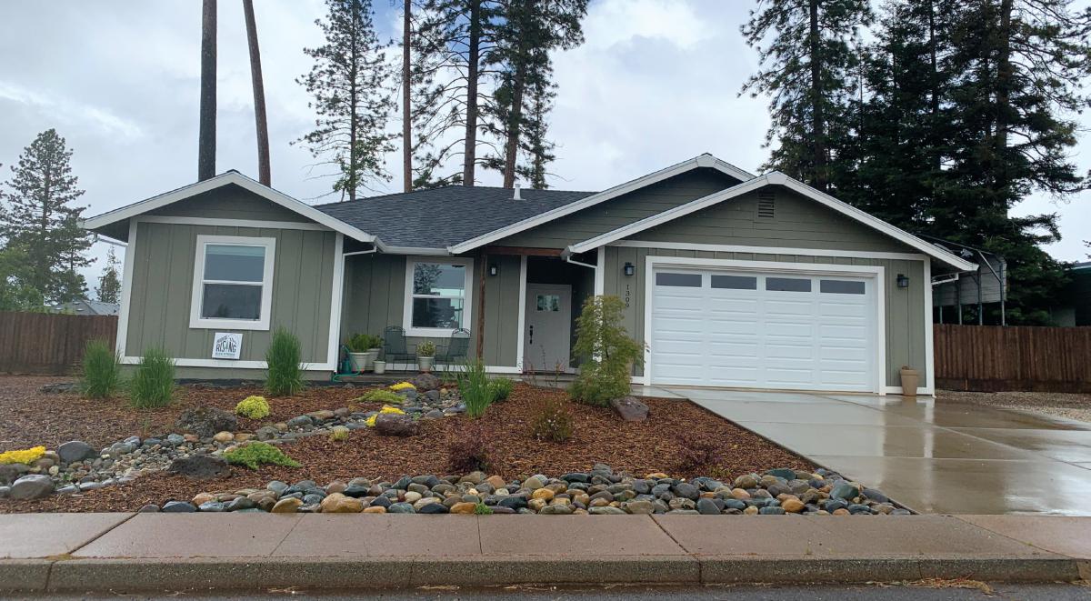 Front view of a one-story house with front yard and driveway.