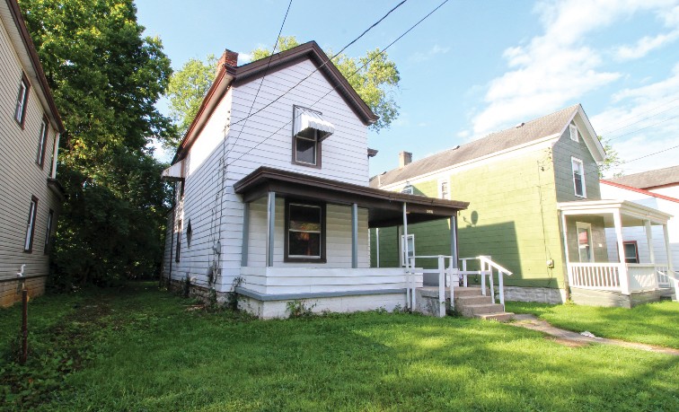 Angled front view of two narrow single-family homes.