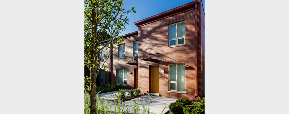 Photograph of the entrances to two 2-story, brick apartments.