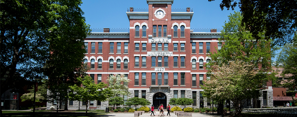 Photograph of the front façade of the historic Jonas Clark Hall, a four-story brick academic building with a five-story clock tower marking the entrance.