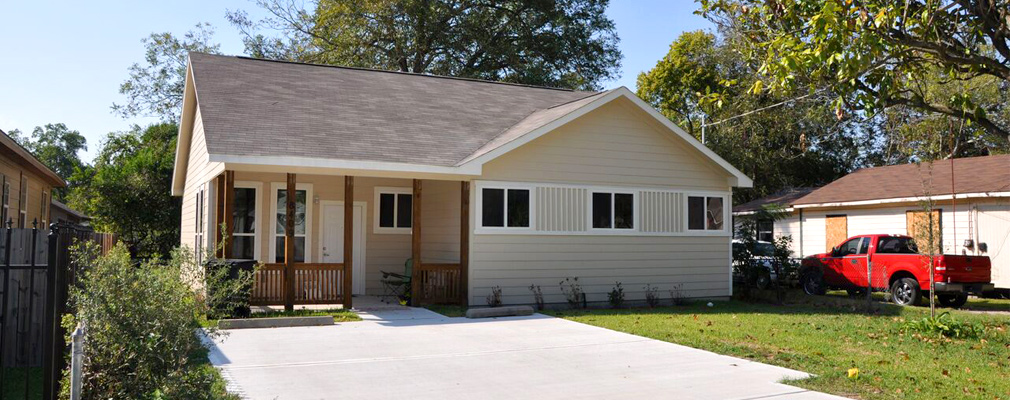 Photograph of the front façade of a newly constructed, one-story single-family house.