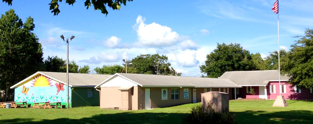 Photograph of Orange County Academy, a group of three one-story buildings.