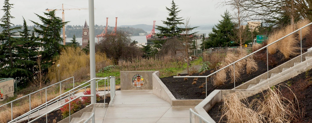 Photograph of a staircase and a graded pedestrian path on a hill.