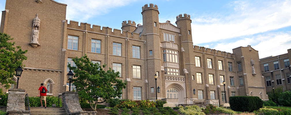 Photograph of the front façade of Hinkle Hall, a 3-story Tudor-Gothic academic building.