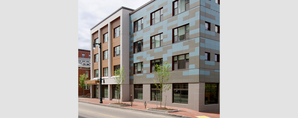 Photograph of the front façade of a four-story apartment building. 