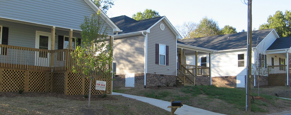 Photograph of the front façades of three one-story single-family detached houses.