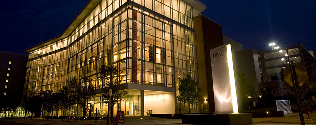 Photograph taken at night of a multistory institutional building.