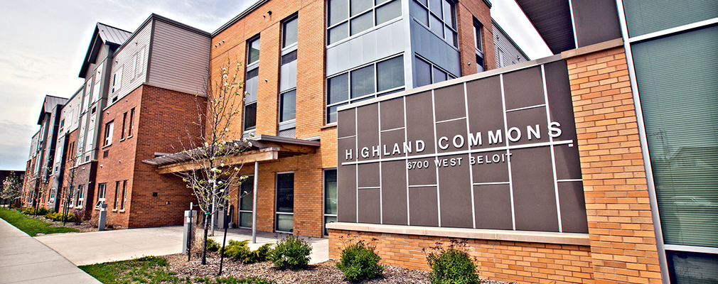 Photograph of the front façade of a three-story multifamily building.