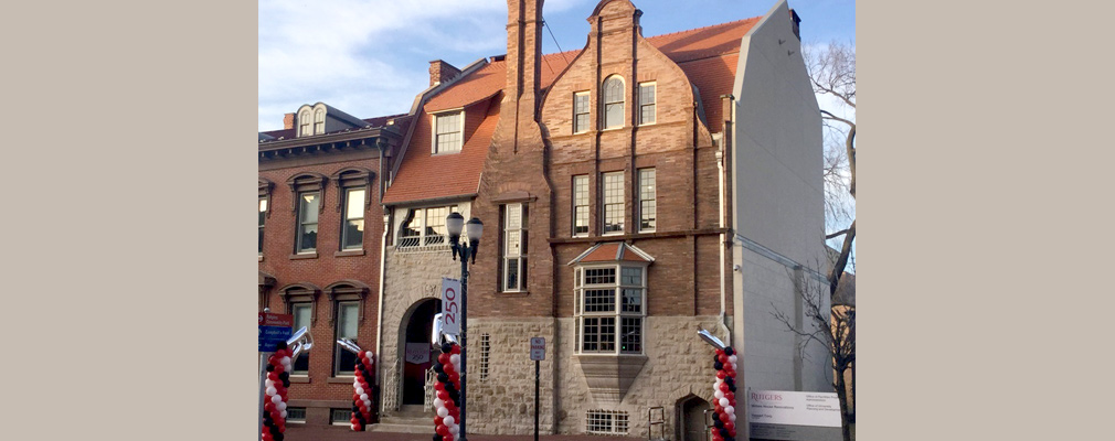 Photograph of the front façade of a three-story, brick Queen Anne style house.