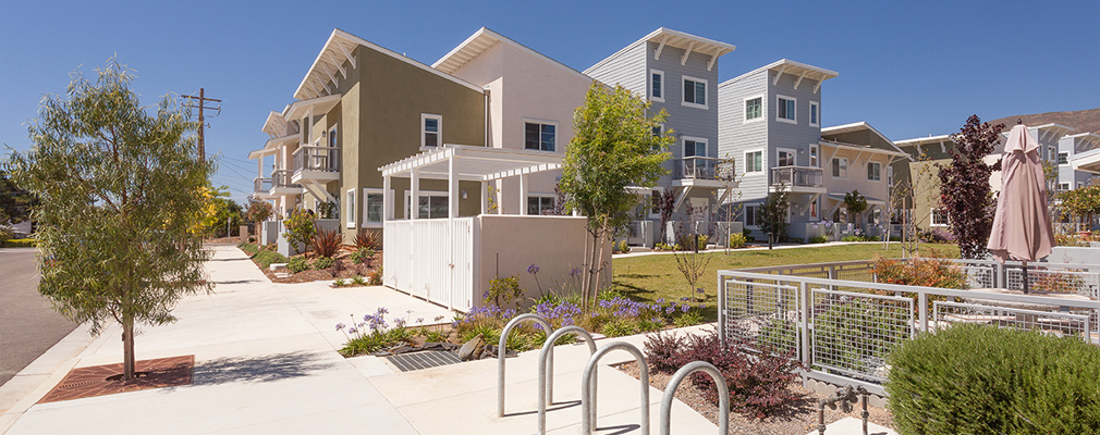Photograph of a bicycle rack near the common greenspace lined with townhouses.