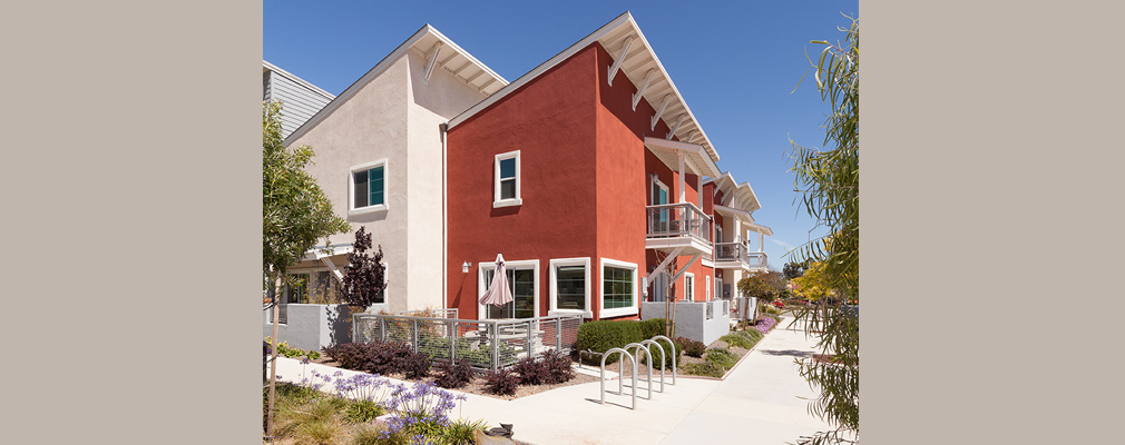 Photograph of the front and side of a townhouse unit and the windows providing natural light.