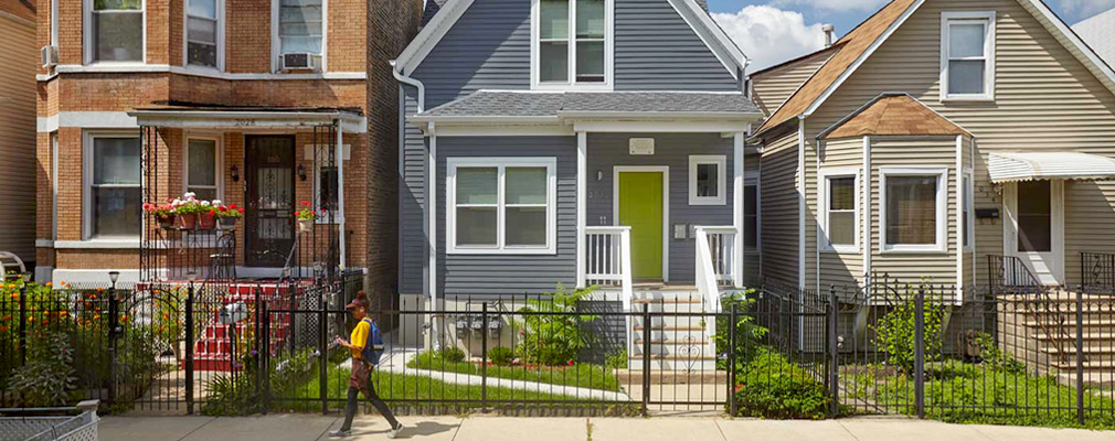 Photograph of the front façades of three 2-story houses.