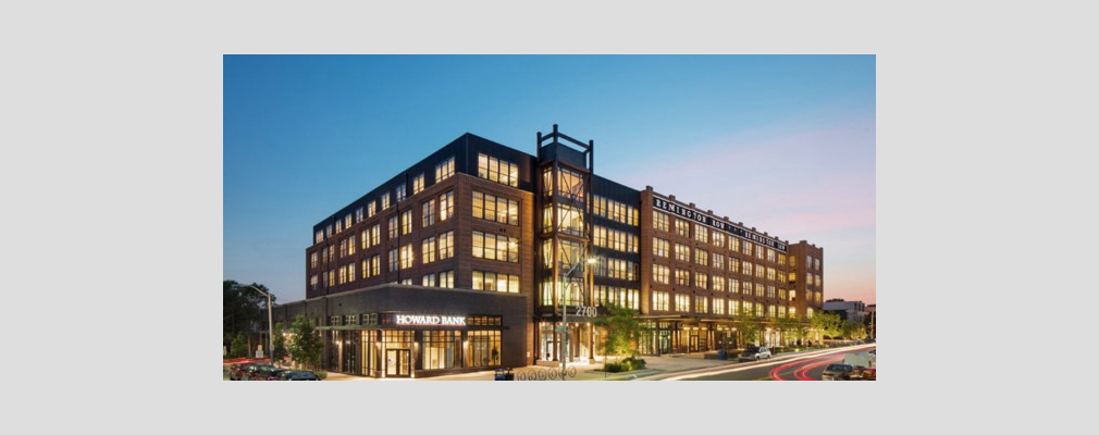 Photograph of two façades of a five-story mixed-use building.