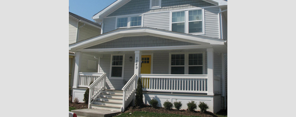 Photograph of the front façade of a two-story single-family house after renovation.