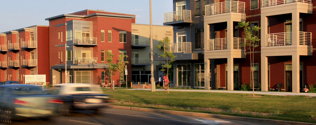 Photograph of two 3-story mixed-use buildings. 