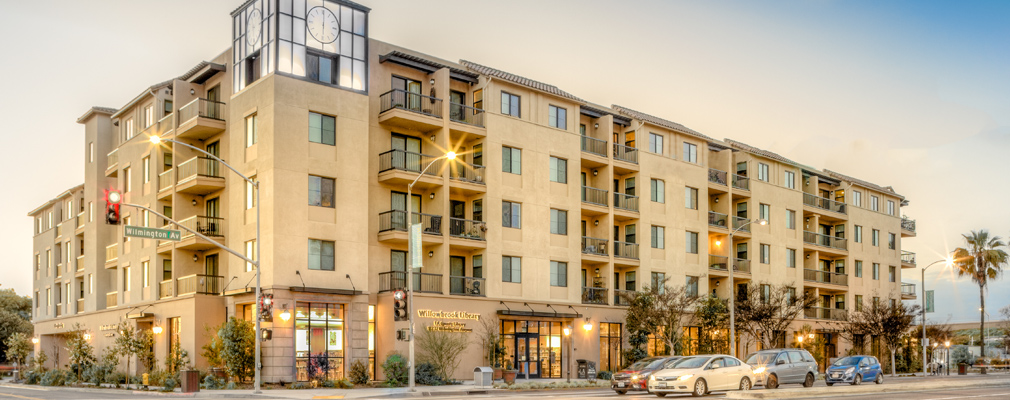 Photograph of two façades of a five-story mixed-use building.