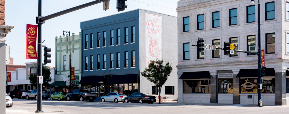 Photograph of two 3-story buildings, the National Bank and Opera House Hotel buildings, that are one half of Block22.