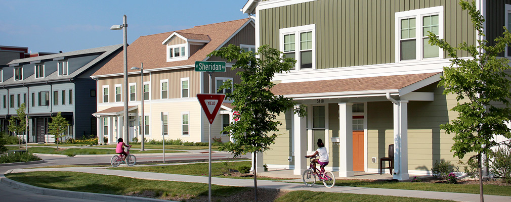 Photograph of three 2-story buildings of attached residential units.  