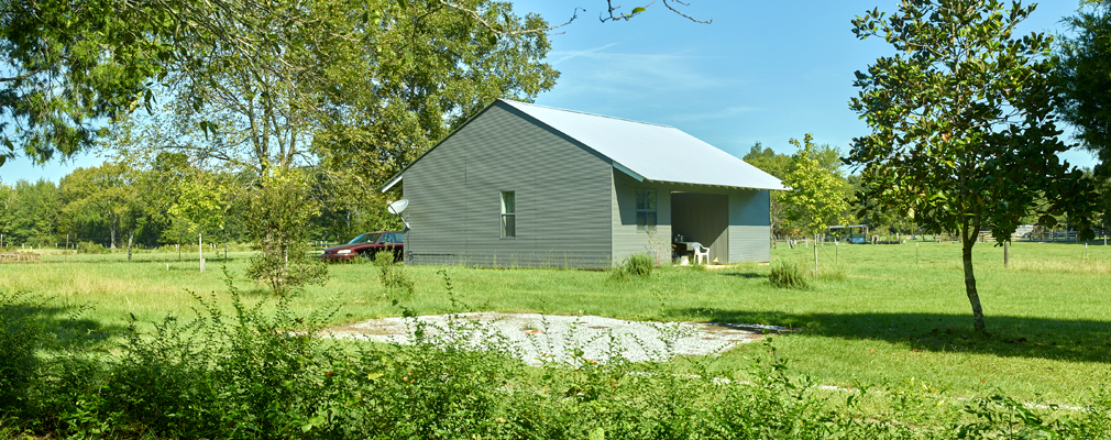 Photograph of a one-story single-family house with a recessed front porch.