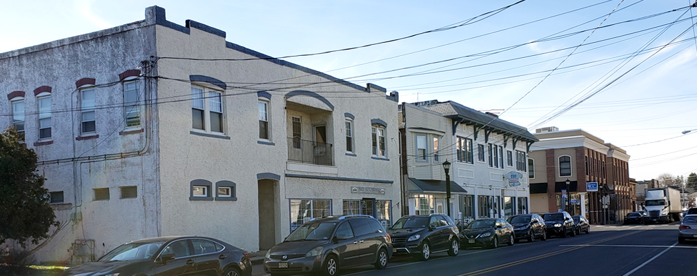 Photograph of several 2-story, mixed-use buildings on High Street, one of two intersecting commercial corridors in downtown Glassboro.